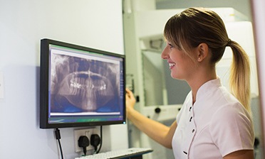dentist looking at a patient’s X-rays 