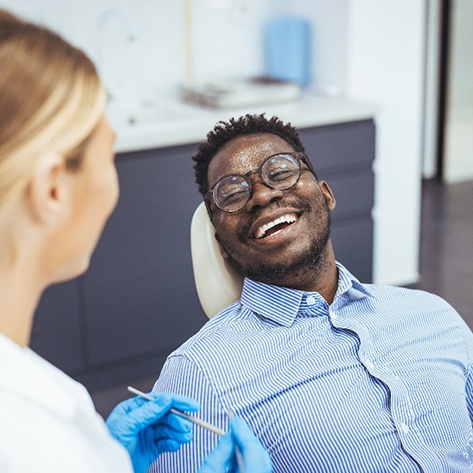 Patient smiling at dentist during dental checkup