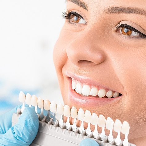 3 dental crowns made from different materials lying on a table