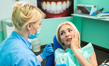 A patient consulting a dentist about the cost of emergency dentistry in West Loop