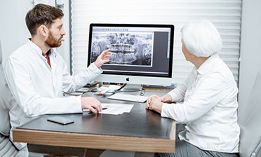 dentist showing a patient their X-rays 