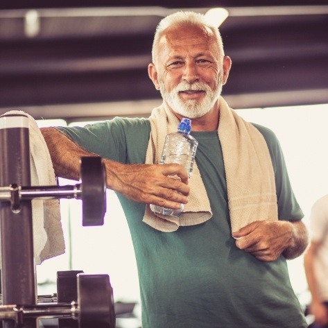 Man smiling after dental implant tooth replacement