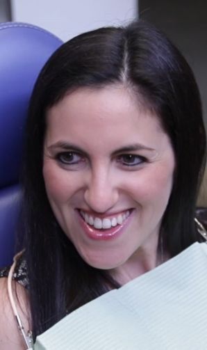 Woman smiling in dental chair in West Loop Chicago