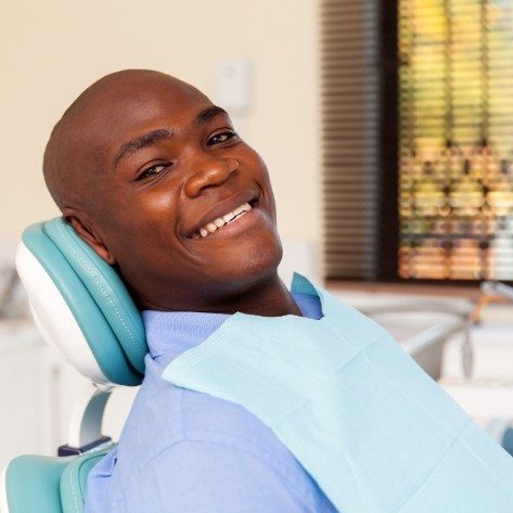 Man smiling during preventive dentistry checkup and teeth cleaning visit