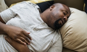 Man sleeping soundly thanks to sleep apnea therapy