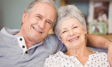 Man and woman with healthy smile after restorative dentistry