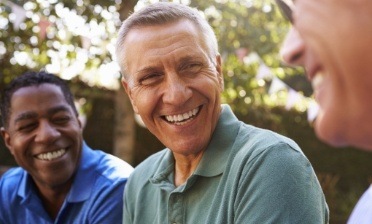 Man sharing healthy new smile after replacing missing teeth