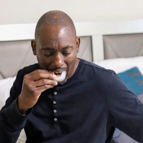 Man placing an occlusal spling for T M J therapy