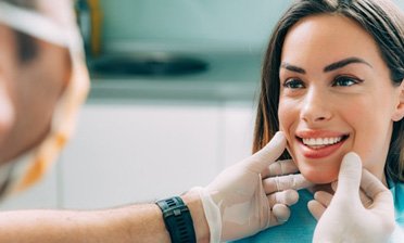 a patient smiling after receiving her new veneers 