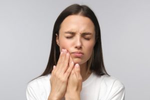 Closeup of woman experiencing tooth pain