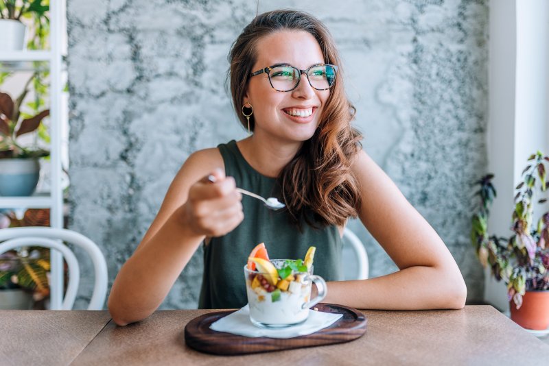 woman smiling and eating