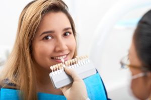 young woman getting veneers from her dentist 