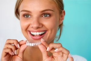 a closeup of a patient smiling with their Invisalign