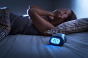 Woman suffering sleep apnea in the middle of the night. 